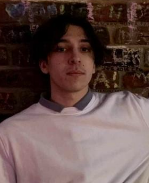 A young man in a white shirt.